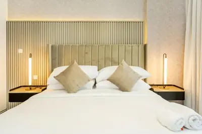a large white bed with pillows in a bedroom at Elegant 2BR with Maids Room City Walk in Dubai