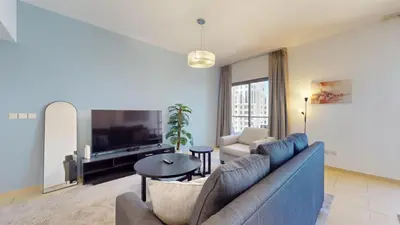 a living room with a couch and a tv at Vacationer l Cozy 2 Bed l Breathtaking Sea and Ain Dubai Views in Dubai
