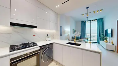 a white kitchen with a stove and a dishwasher at Vacationer l Elegant 1 Bedroom l Near to Park and Mall l JVC in Dubai