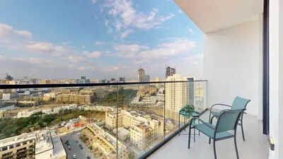 a balcony with a view of a city at Vacationer l Elegant 1 Bedroom l Near to Park and Mall l JVC in Dubai