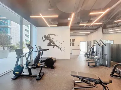 a gym with treadmills and cardio equipment in a building at Vacationer l Chic Upgraded Studio l City Views l Dubai Marina in Dubai