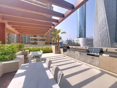 a rooftop patio with a table and chairs on a building at Vacationer l Chic Upgraded Studio l City Views l Dubai Marina in Dubai