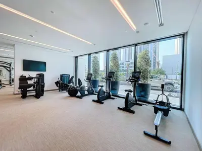 a gym with treadmills and exercise equipment in a building at Vacationer l 1 Bedroom in Creek Harbour l Skyline Views in Dubai