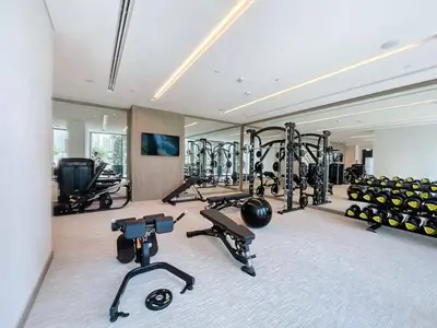 a gym with several treadmills and exercise bikes at Vacationer l 1 Bedroom in Creek Harbour l Skyline Views in Dubai