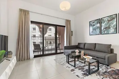 a living room with a couch and a table at The Smart Concierge - Andalus Jumeirah Golf Estates in Dubai