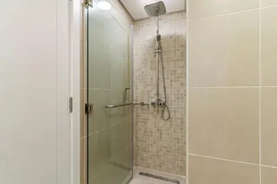 a bathroom with a shower with a glass door at The Smart Concierge - Andalus Jumeirah Golf Estates in Dubai