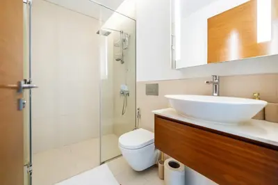 a bathroom with a sink and a toilet and a shower at Elegant 3BR with Maids Room City Walk Dubai in Dubai