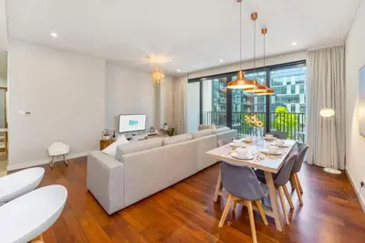 a living room with a couch and a table at Stylish 2BR with Maids Room City Walk in Dubai