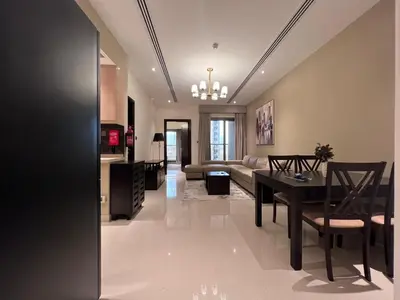 a living room with a table and a couch at Elite Residence 1, Downtown Dubai in Dubai