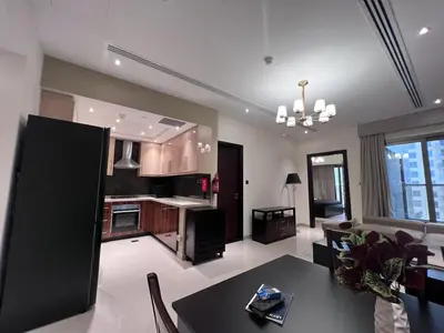 a kitchen and living room with a table and chairs at Elite Residence 1, Downtown Dubai in Dubai