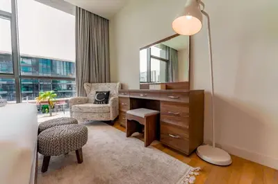 a room with a desk and a chair and a mirror at Spacious 2BR with Maids Room City Walk in Dubai