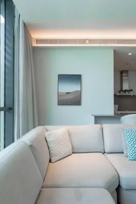 a white couch sitting in a living room at Spacious 2BR with Maids Room City Walk in Dubai