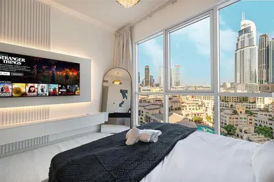 a bedroom with a large bed and a large window at Large 4 Bed Apt with Burj View and 8 Min Walk to Mall by Vista Stays DXB in Dubai