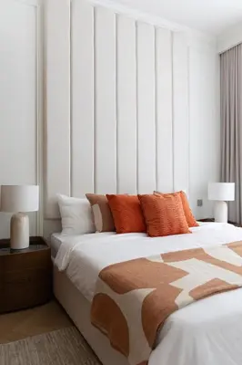 a bedroom with a large bed with orange pillows at Luxury & Modern Unit in Emaar Beachfront in Dubai