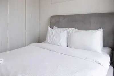 a white bed with white sheets and pillows at Zada Tower, Business Bay - Onelink in Dubai