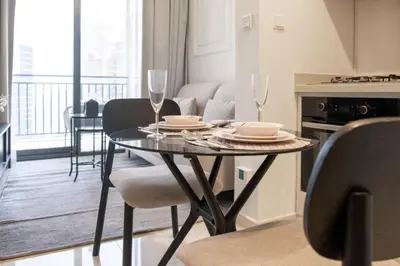 a dining room table with two wine glasses on it at Zada Tower, Business Bay - Onelink in Dubai