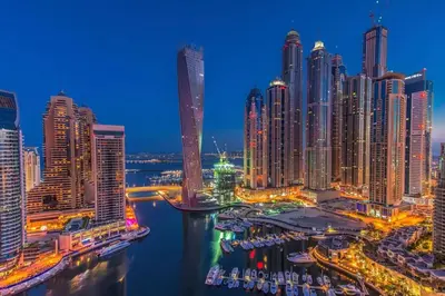 a view of a city skyline at night at Cayan Tower, Dubai Marina - Onelink in Dubai