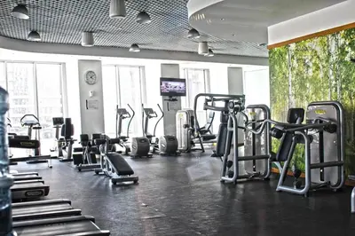 a gym with several treadmills and cardio machines at Cayan Tower, Dubai Marina - Onelink in Dubai