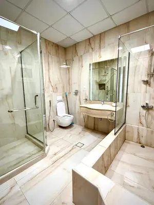 a bathroom with a shower and a toilet and a sink at Risephoenix Japanese Luxury Capsule Villa - Dubai in Dubai