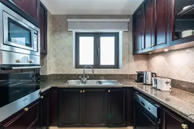 a kitchen with a sink and a window at Silkhaus in Al Tajer in Souk al Bahar Direct Access in Dubai