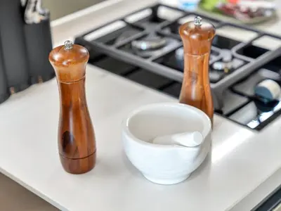 two bottles and a cup on a counter at Peninsula One Suites by Prestige Nest in Dubai