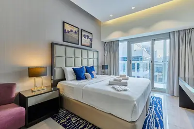 a bedroom with a large bed and a window at Majesty Stay 2BR in Dubai