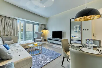 a living room with a couch and a table at Majesty Stay 2BR in Dubai