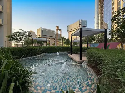 two birds are in a fountain in a city at The Iconic Stay 2BR in Dubai