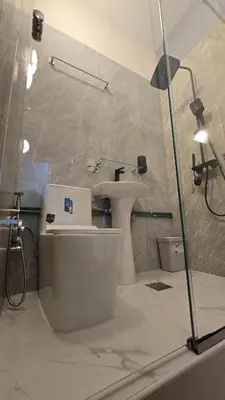 a bathroom with a sink and a toilet and a shower at Partition with attached washroom in Dubai