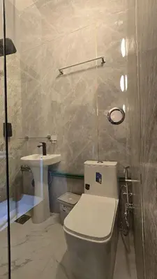 a bathroom with a toilet and a sink at Partition with attached washroom in Dubai