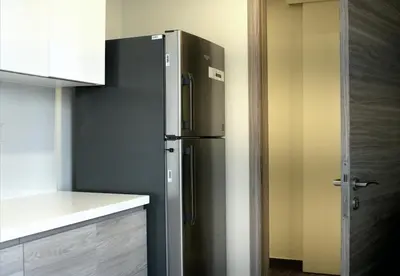 a stainless steel refrigerator in a kitchen at Velvet Rose with Burj and canal view 2Bedrooms in Solbay in Dubai