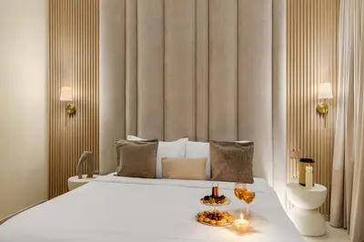 a bedroom with a large white bed with two candles at Full Burj Khalifa & Fountain View 60th Floor Sky Luxury 2BHK 4 mins Walk to Dubai Mall Downtown in Dubai