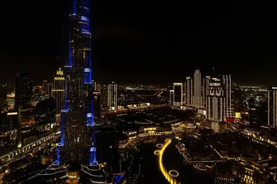 a view of a city at night with at Full Burj Khalifa & Fountain View 60th Floor Sky Luxury 2BHK 4 mins Walk to Dubai Mall Downtown in Dubai