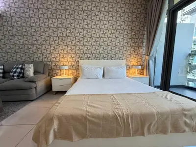 a bedroom with a large bed and a couch at Refined Urban Studio Walk to Circle Mall in Dubai
