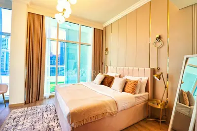 a bedroom with a large bed and a large window at Barsana - Aurelia by JBR Beach - 2 Bed - Marina Views! in Dubai