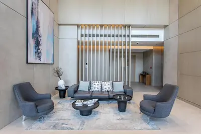 a living room with two chairs and a couch at STAY BY LATINEM Luxury 1BR Holiday Home W-407 near Burj-Khalifa in Dubai
