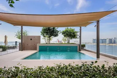 an outdoor swimming pool with a canopy on top of a building at Beachfront 1BR Retreat Beach Isle Tower 01 in Dubai