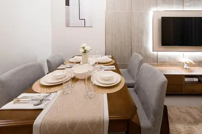 a dining room table with chairs and a television at Stylish 2BR Connected to Dubai Mall with Full Burj Khalifa View in Dubai