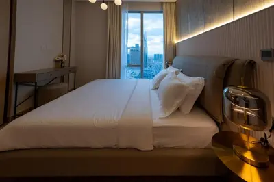 a bedroom with a large bed with a large window at Stylish 2BR Connected to Dubai Mall with Full Burj Khalifa View in Dubai