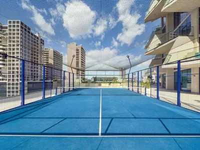 a tennis court in the middle of a city at Chic 1BR Retreat with Private Pool and Balcony in JVC in Dubai