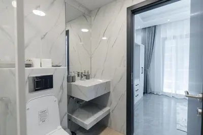 a bathroom with a sink and a shower at Dubai Marina - 1BHK Apartment near Dubai Metro in Dubai