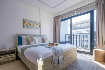a bedroom with a large bed and a large window at Frank Porter - Sunrise Legend in Dubai
