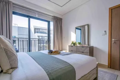 a bedroom with a bed and a large window at Frank Porter - Sunrise Legend in Dubai