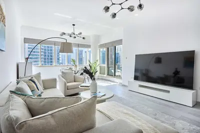 a living room with a large flat screen tv at Frank Porter - Al Majara, Dubai Marina in Dubai