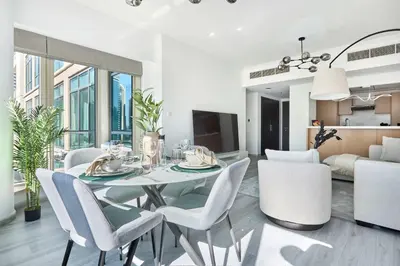 a dining room and living room with a table and chairs at Frank Porter - Al Majara, Dubai Marina in Dubai