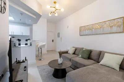 a living room with a couch and a table at Dubai Marina - 1BHK Cozy Vacation Homes near Metro in Dubai