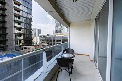 a balcony with two chairs and a table on it at Dubai Marina - 1BHK Cozy Vacation Homes near Metro in Dubai