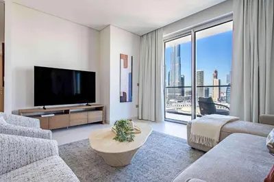 a living room with a television and a large window at Frank Porter - Vida Dubai Mall, Downtown in Dubai