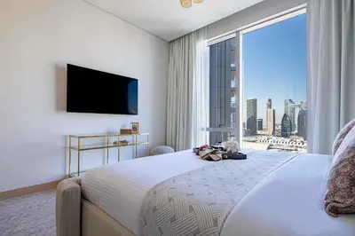 a bedroom with a large bed with a large window at Frank Porter - Vida Dubai Mall, Downtown in Dubai