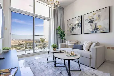 a living room with a couch and a table at Frank Porter - Skyz By Danube in Dubai